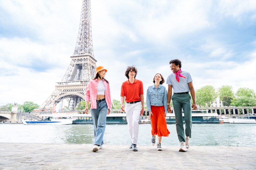 Group of young happy friends visiting Paris and Eiffel Tower